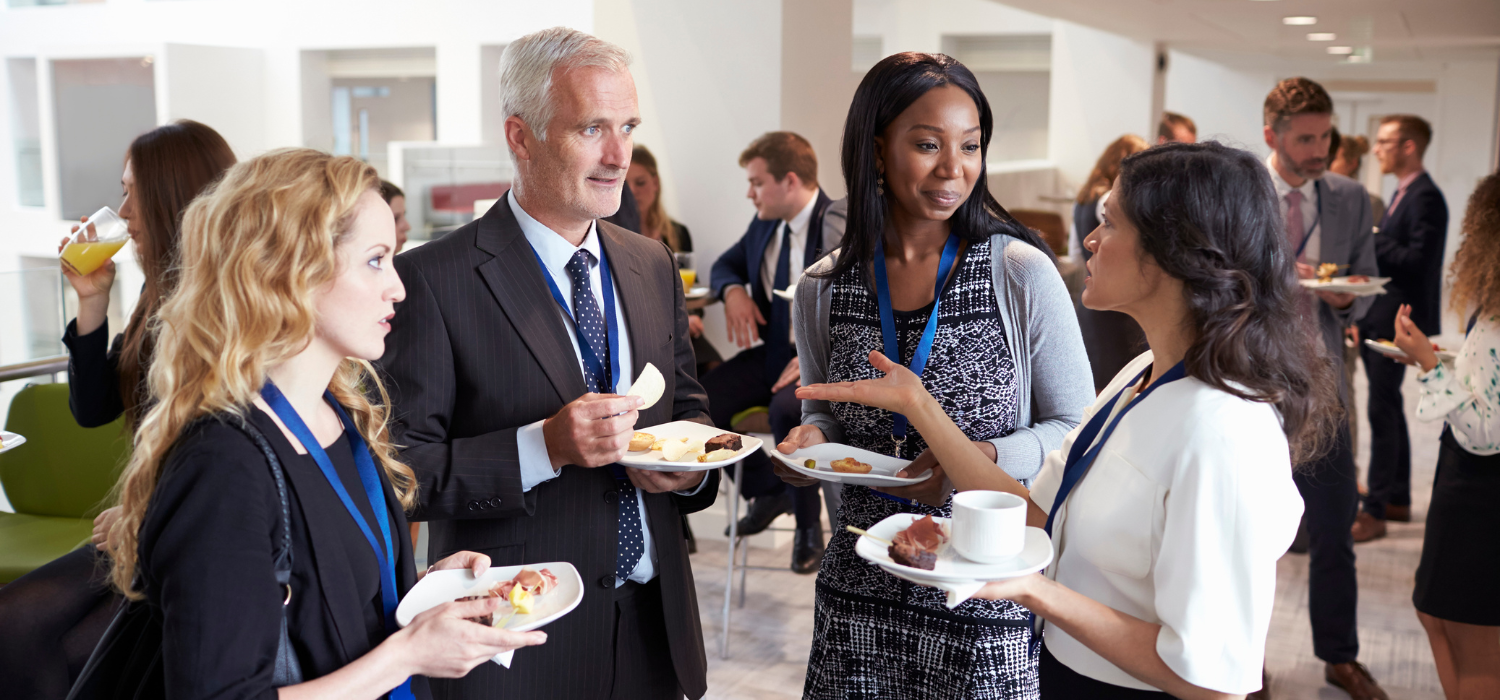 A group of people are networking and discussing matters regarding how to increase direct bookings for hotels.
